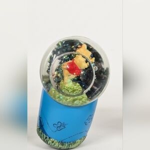 A charming vintage Winnie the Pooh mini 100 acre musical snow globe